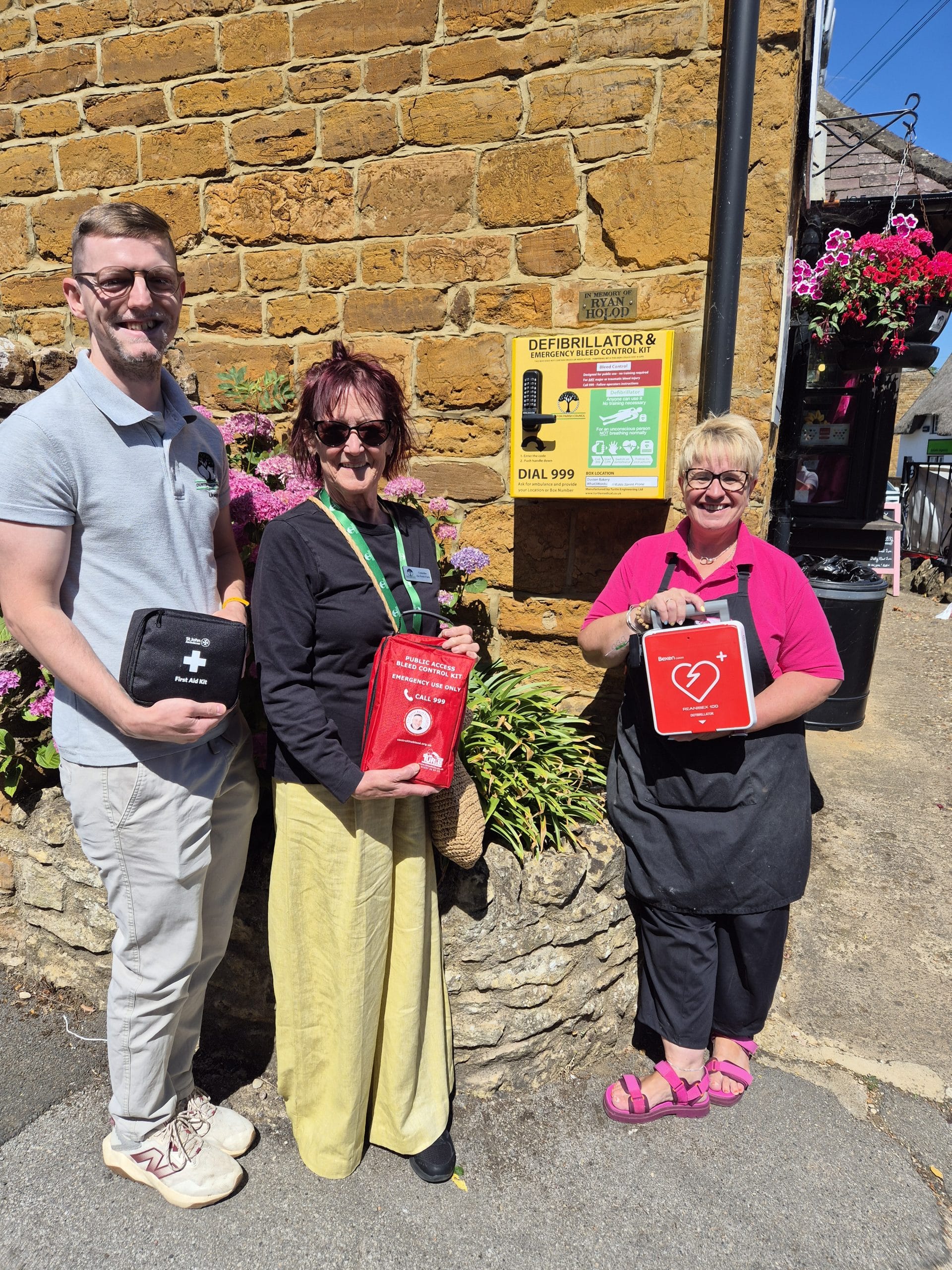 Duston Village Bakery AED with DefibTrack - Duston Parish Council representatives with the bakery owner.