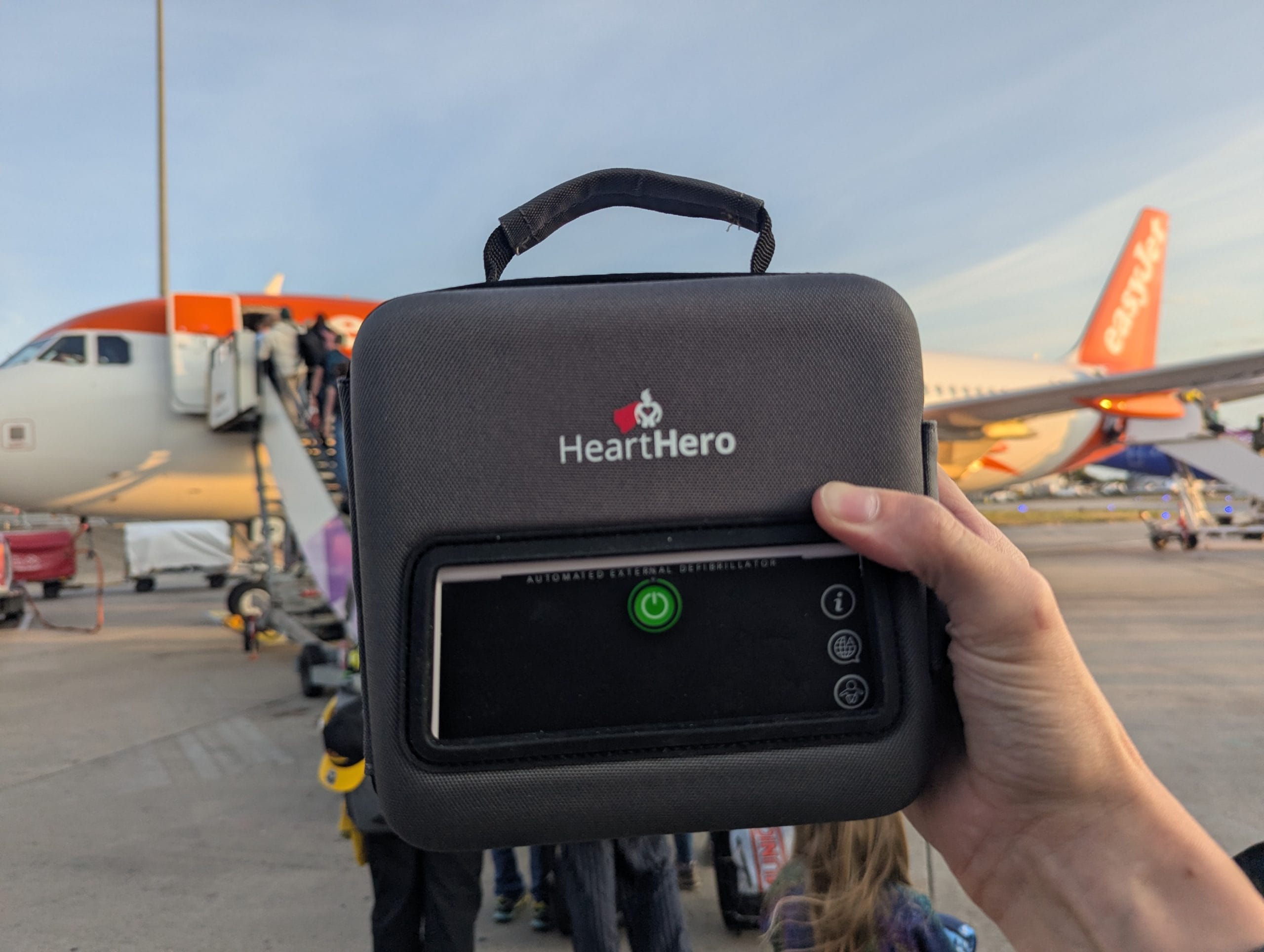 HeartHero Elliot on the airport runway HeartHero Elliot defibrillator being held on the airport runway as it's taken on a trip to test it.